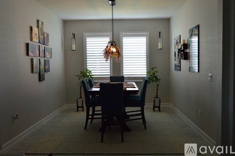 A dining room with a table set for four.