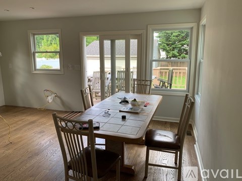 A dining room with a table and chairs.