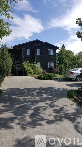 A house with a car parked in front of it.