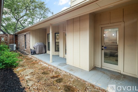 A beige building with a glass door and windows.