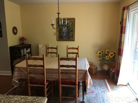 A dining room with a table set for six.