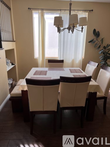 A dining room with a table set for four.