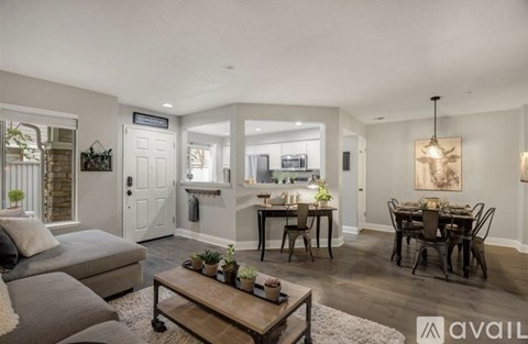 A living room with a grey couch and a wooden coffee table.