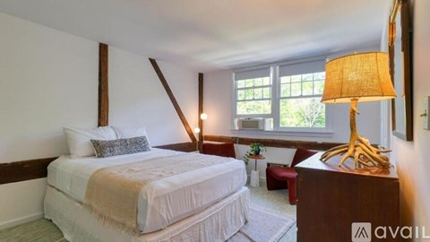 A bedroom with a large bed and a wooden headboard.