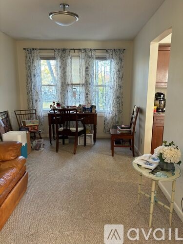A living room with a dining table and chairs.