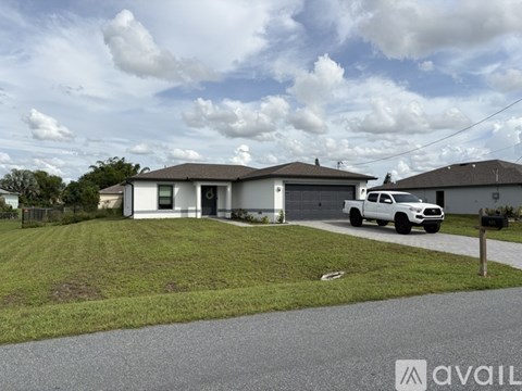 A house with a white pickup truck parked in front.