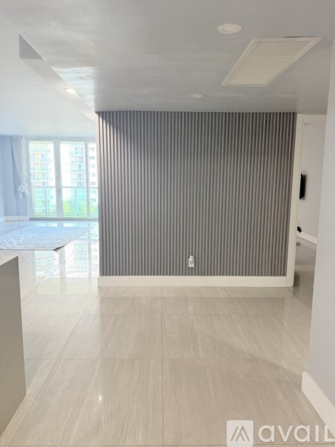 A room with a striped curtain and a white floor.