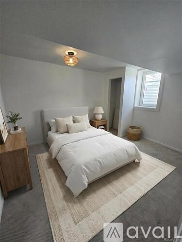 A bedroom with a large bed and a wooden nightstand.