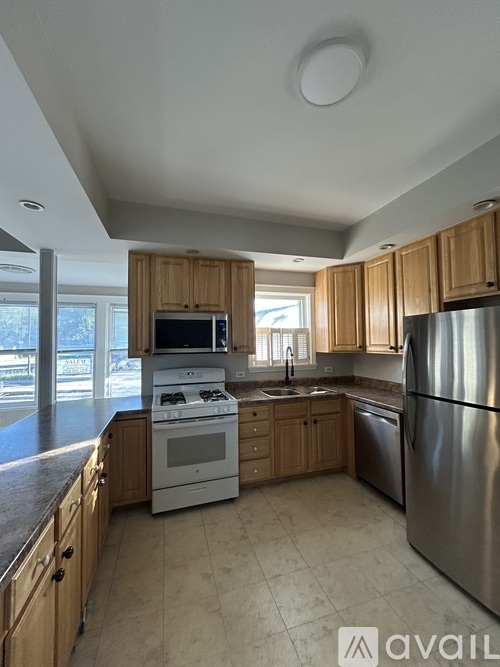A kitchen with wooden cabinets and stainless steel appliances.