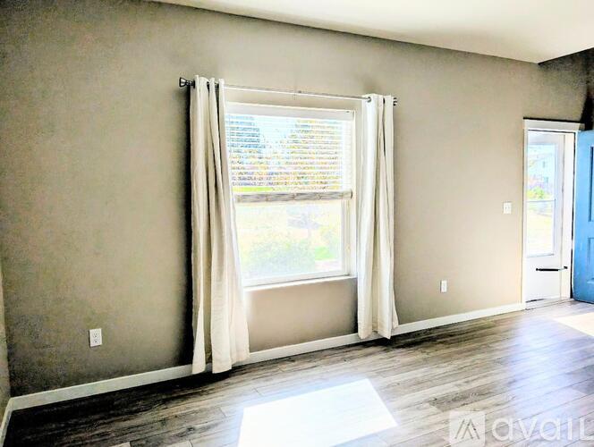 A room with a window and a door.