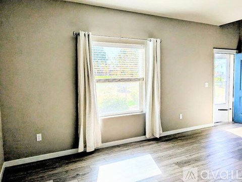 A room with a window and a door.