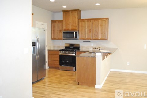 A kitchen with wooden cabinets and stainless steel appliances.