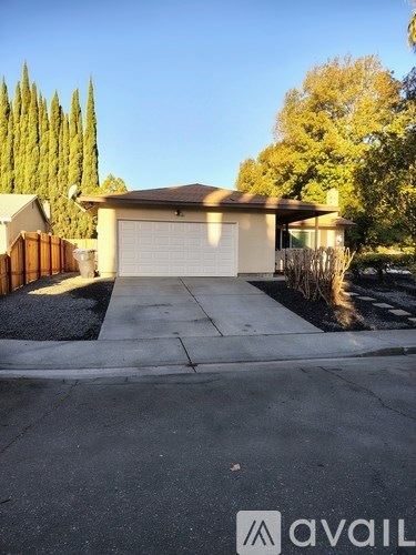 A house with a white garage door is for sale.