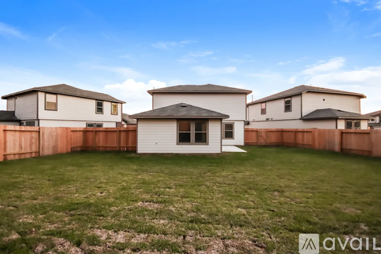 A row of houses with a grassy front yard.