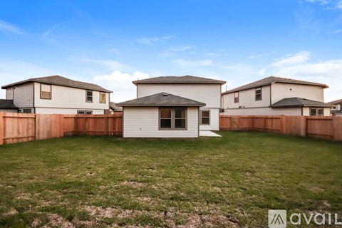 A row of houses with a grassy front yard.