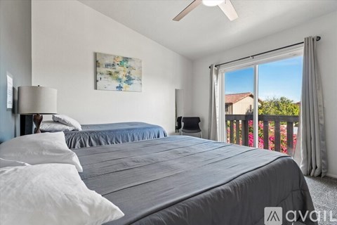 A bedroom with two beds and a painting on the wall.