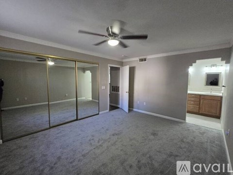 A spacious room with a ceiling fan and glass doors.