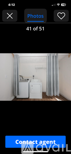 A white washing machine and dryer in a small room.