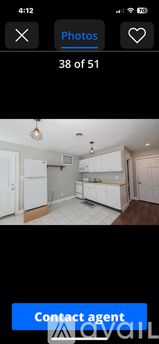 A kitchen with white cabinets and a wooden floor.