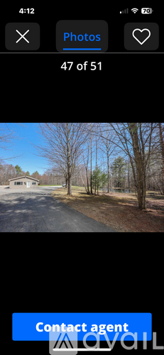 A photo gallery app with a photo of a house and trees.