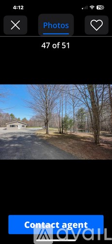 A photo gallery app with a photo of a house and trees.