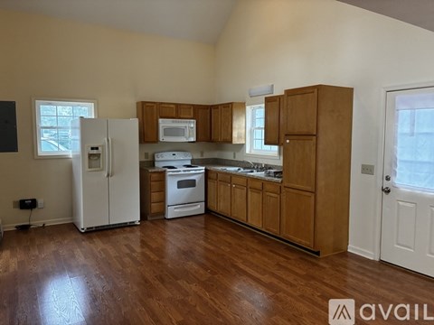 A kitchen with wooden cabinets and a white refrigerator.