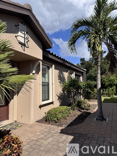 A house with a palm tree in front of it.