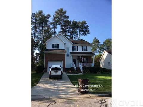 A white house with a garage is located at 6509 Caverstone Ln, Durham, NC.