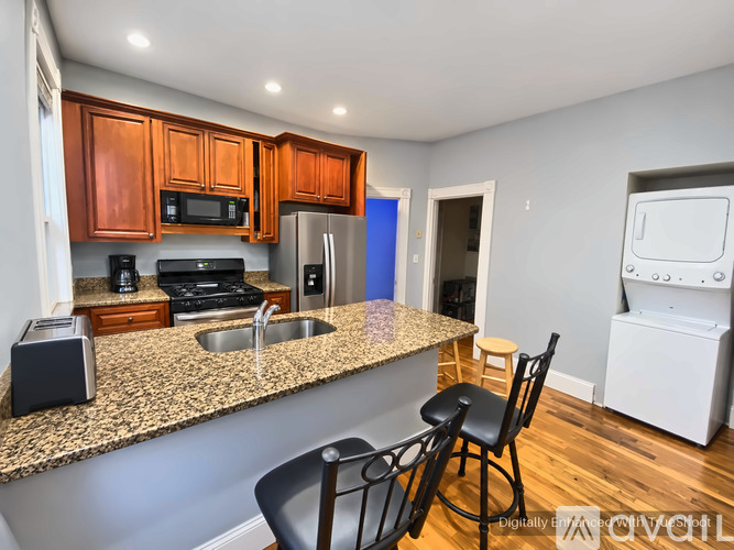 A kitchen with granite countertops and a sink.