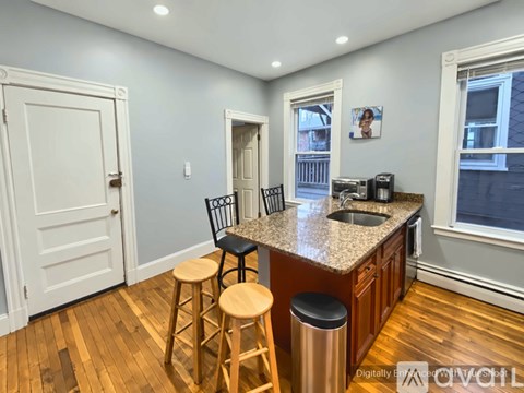 A kitchen with a bar stool and a counter.