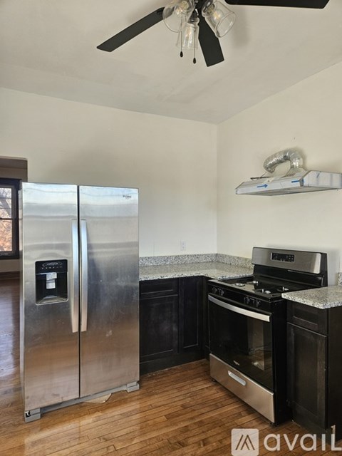 A kitchen with a stainless steel refrigerator and a stainless steel oven.