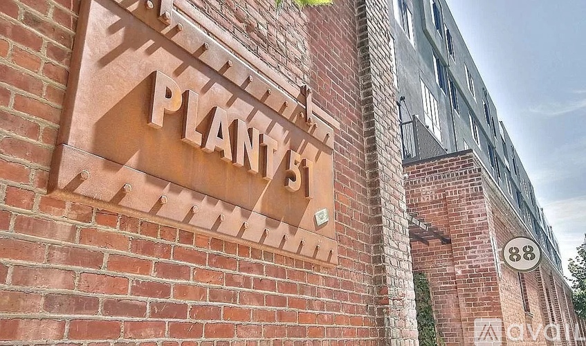 A brick wall with a sign that says "Planty's" on it.
