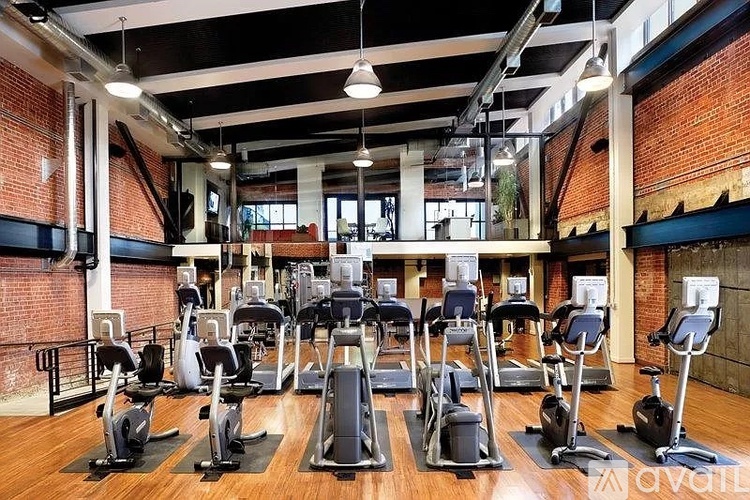 A gym with treadmills and elliptical machines.