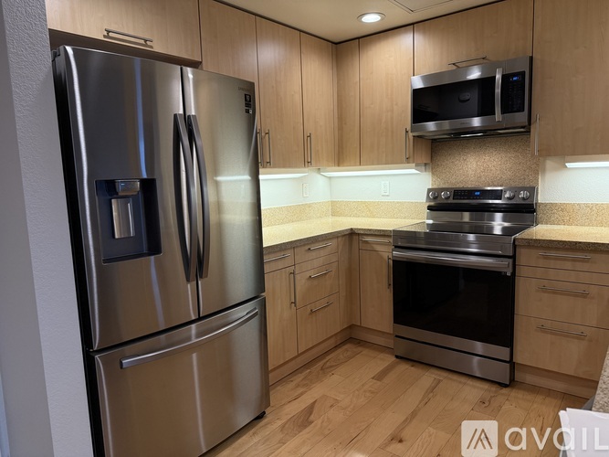 A kitchen with wooden cabinets and stainless steel appliances.