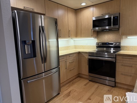 A kitchen with wooden cabinets and stainless steel appliances.