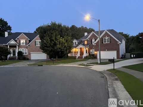 A street view of a residential area with houses and a streetlight.