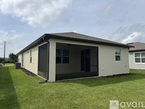 A house with a brown roof and a white exterior is available for rent.