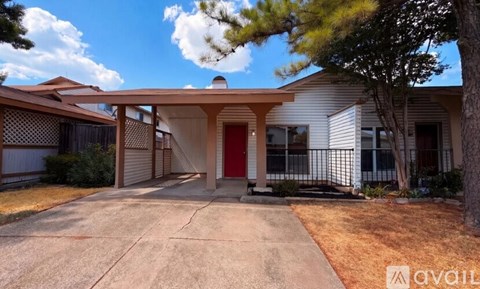 A house with a red door is for sale.