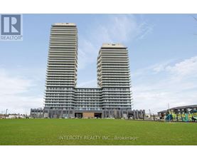 Two identical buildings stand side by side in a grassy field.