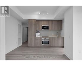 A modern kitchen with wooden cabinets and stainless steel appliances.