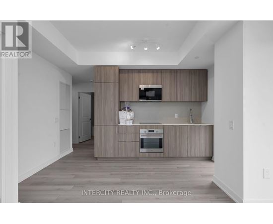A modern kitchen with wooden cabinets and stainless steel appliances.