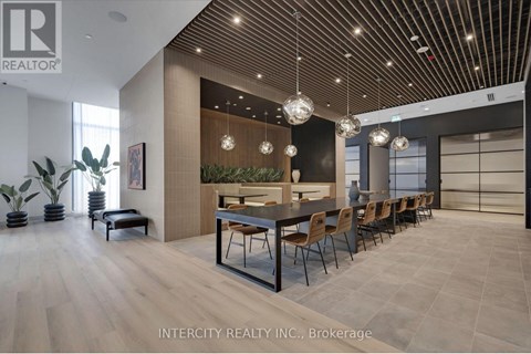 A modern dining room with a long table and chairs.