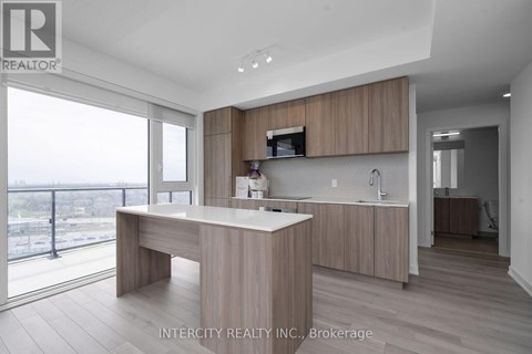 A modern kitchen with wooden cabinets and a large island.