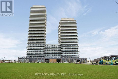 Two identical buildings stand side by side in a grassy field.