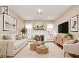 A living room with a fireplace, a couch, a chair, and a television.