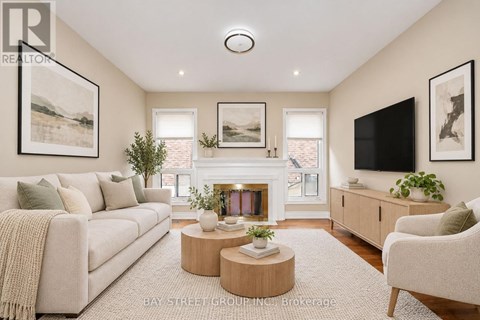 A living room with a fireplace, a couch, a chair, and a television.