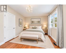 A bedroom with a large bed and a chandelier.