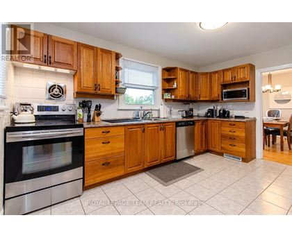 A kitchen with wooden cabinets and stainless steel appliances.