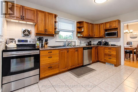 A kitchen with wooden cabinets and stainless steel appliances.