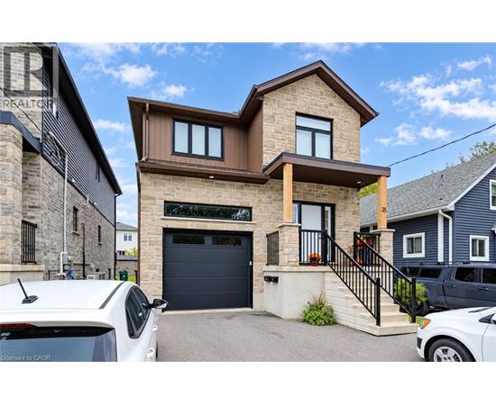 A modern house with a garage and a car parked in front.